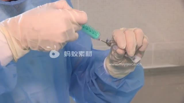 一名医务人员正在将药液注入注射器中-第1张图