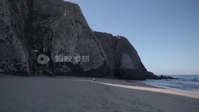 海滩旁的雄伟的岩石男人在海滩上凝视大海风景-第2张图